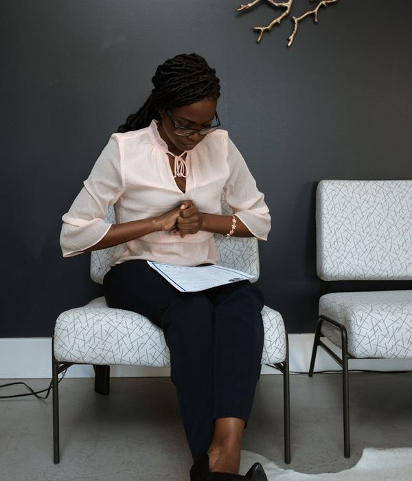 Person doing a calming yoga pose in a modern office environment.